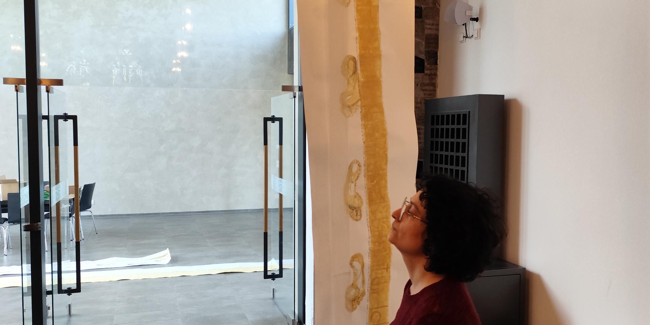 Maryam Aghaalikani beim Aufhängen ihrer Installation 'Drahtseilakt'